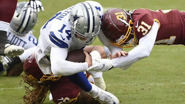 LANDOVER, MARYLAND - OCTOBER 25: Quarterback Andy Dalton #14 of the Dallas Cowboys is tackled by Kamren Curl #31 of the Washington Football Team in the first half of the game at FedExField on October 25, 2020 in Landover, Maryland. The Washington Football Team won 25-3.