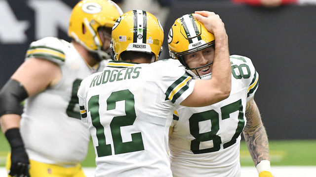HOUSTON, TEXAS - OCTOBER 25: Aaron Rodgers #12 of the Green Bay Packers celebrates with Jace Sternberger #87 after a touchdown against the Houston Texans during the second quarter at NRG Stadium on October 25, 2020 in Houston, Texas.