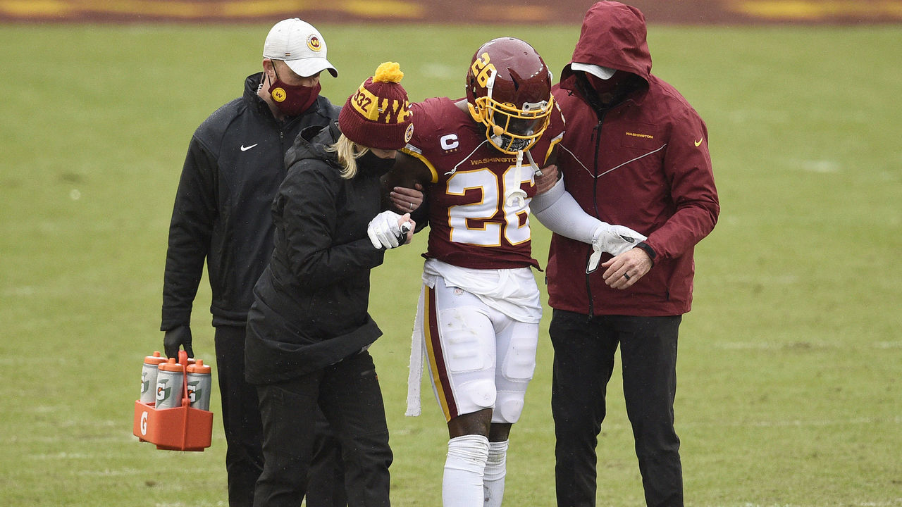 LANDOVER, MARYLAND - OCTOBER 25: Landon Collins #26 of the Washington Football Team is helped off the field after being injured in the first half against the Dallas Cowboys at FedExField on October 25, 2020 in Landover, Maryland.