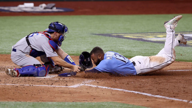 ARLINGTON, TEXAS - OCTOBER 25: Manuel Margot #13 of the Tampa Bay Rays is tagged out by Austin Barnes #15 of the Los Angeles Dodgers on an attempt to steal home during the fourth inning in Game Five of the 2020 MLB World Series at Globe Life Field on October 25, 2020 in Arlington, Texas.