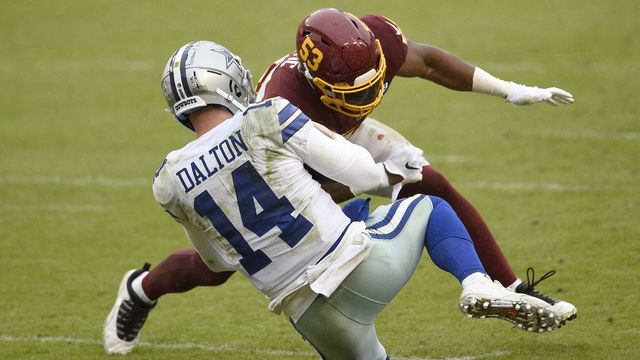 LANDOVER, MARYLAND - OCTOBER 25: Quarterback Andy Dalton #14 of the Dallas Cowboys is hit and injured by Jon Bostic #53 of the Washington Football Team in the third quarter of the game at FedExField on October 25, 2020 in Landover, Maryland.