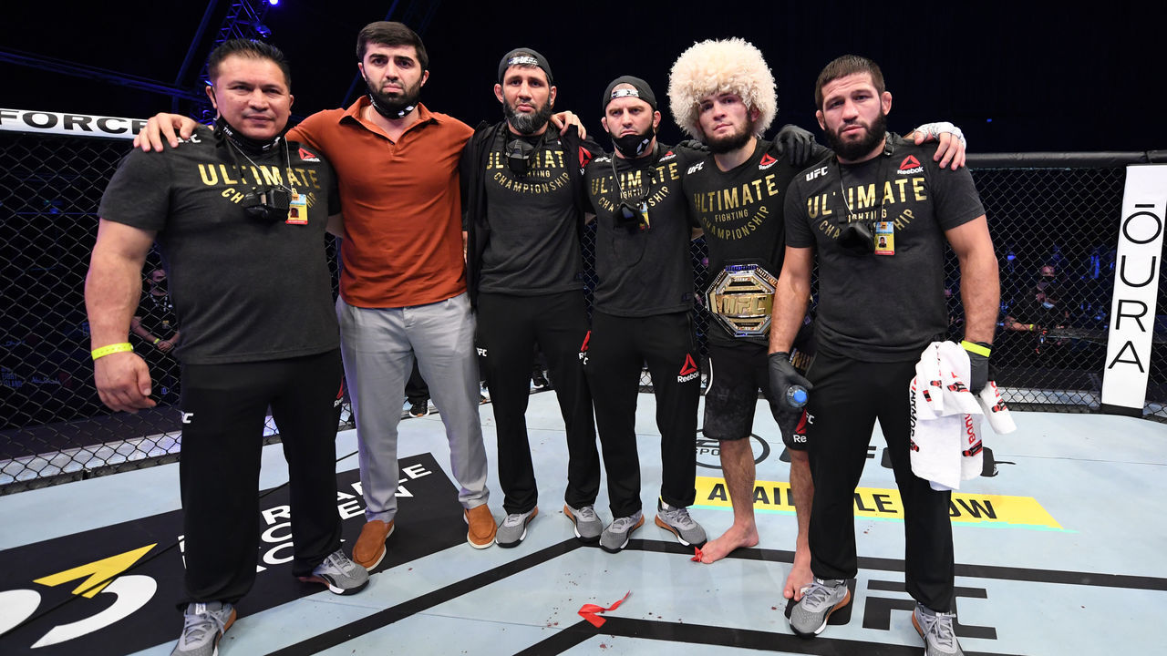 ABU DHABI, UNITED ARAB EMIRATES - OCTOBER 25: Khabib Nurmagomedov of Russia poses for a photo in the Octagon with his team after his lightweight title bout against Justin Gaethje during the UFC 254 event on October 25, 2020 on UFC Fight Island, Abu Dhabi, United Arab Emirates.