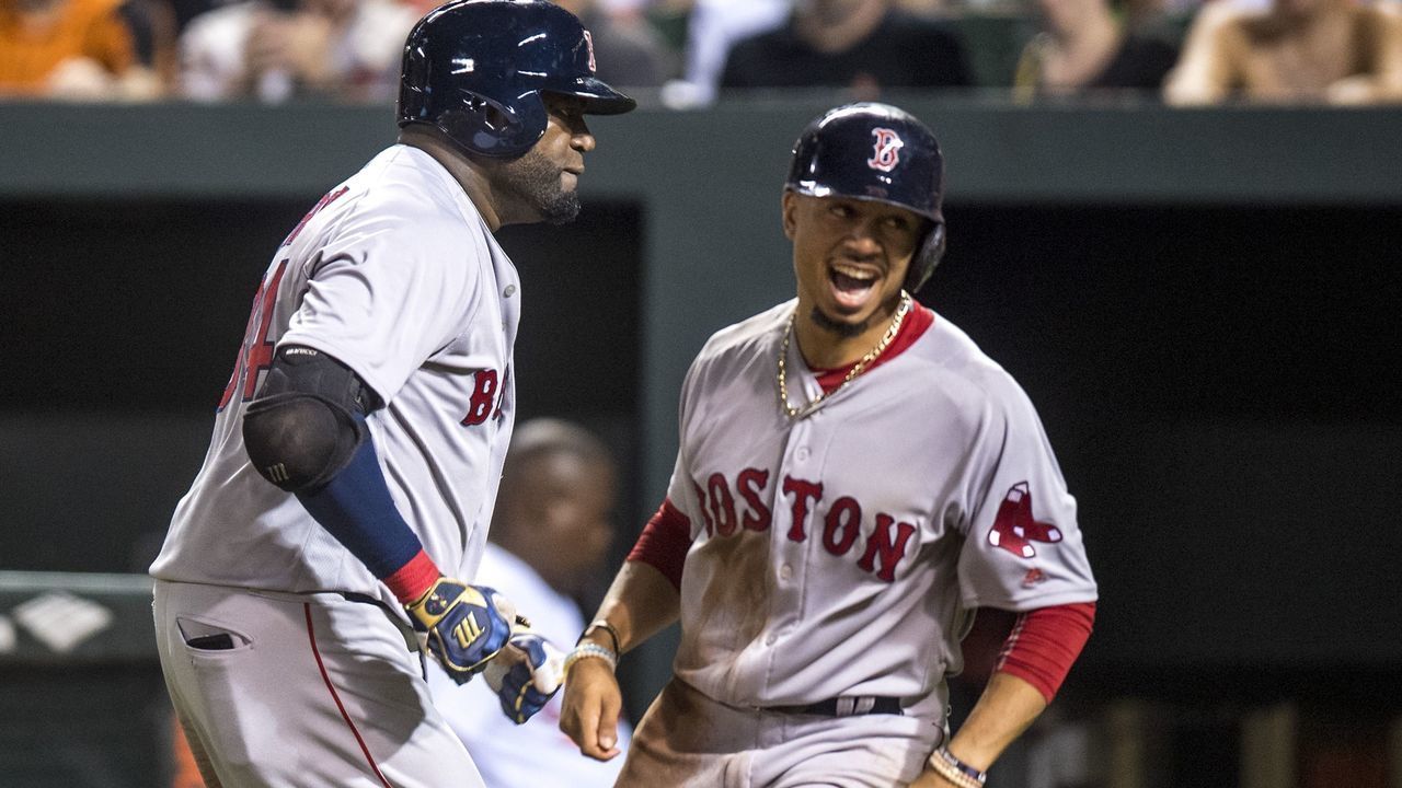 BALTIMORE, MD - SEPTEMBER 20: David Ortiz #34 of the Boston Red Sox reacts with Mookie Betts #50 after hitting a three run home run during the seventh inning of a game against the Baltimore Orioles on September 20, 2016 at Oriole Park at Camden Yards in Baltimore, Maryland.