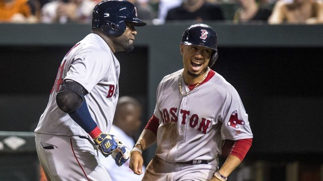 BALTIMORE, MD - SEPTEMBER 20: David Ortiz #34 of the Boston Red Sox reacts with Mookie Betts #50 after hitting a three run home run during the seventh inning of a game against the Baltimore Orioles on September 20, 2016 at Oriole Park at Camden Yards in Baltimore, Maryland.