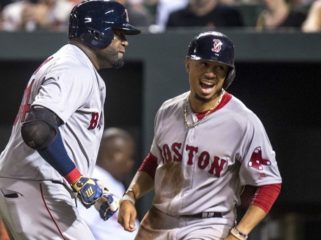 BALTIMORE, MD - SEPTEMBER 20: David Ortiz #34 of the Boston Red Sox reacts with Mookie Betts #50 after hitting a three run home run during the seventh inning of a game against the Baltimore Orioles on September 20, 2016 at Oriole Park at Camden Yards in Baltimore, Maryland.