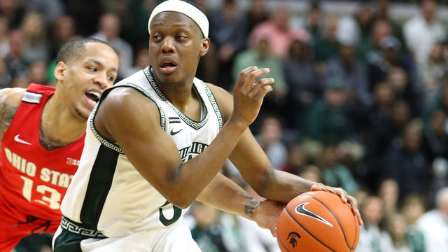 EAST LANSING, MICHIGAN - MARCH 08: Cassius Winston #5 of the Michigan State Spartans drives past CJ Walker #13 of the Ohio State Buckeyes during the first half at the Breslin Center on March 08, 2020 in East Lansing, Michigan.