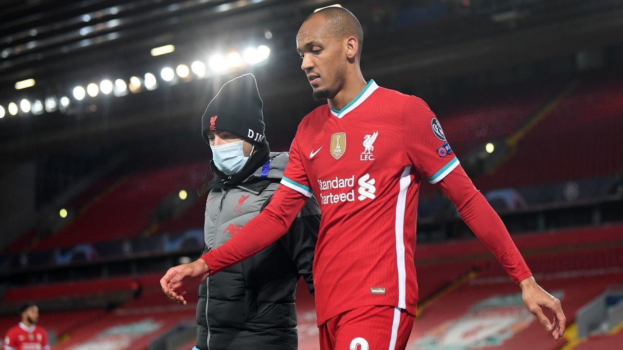 Liverpool's Brazilian midfielder Fabinho leaves the game after picking up an injury during the UEFA Champions league Group D football match between Liverpool and Midtjylland at Anfield in Liverpool, north west England on October 27, 2020.