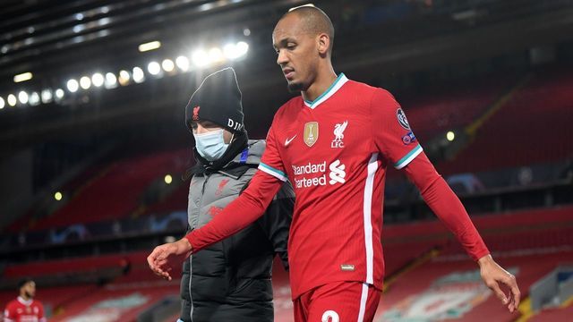 Liverpool's Brazilian midfielder Fabinho leaves the game after picking up an injury during the UEFA Champions league Group D football match between Liverpool and Midtjylland at Anfield in Liverpool, north west England on October 27, 2020.