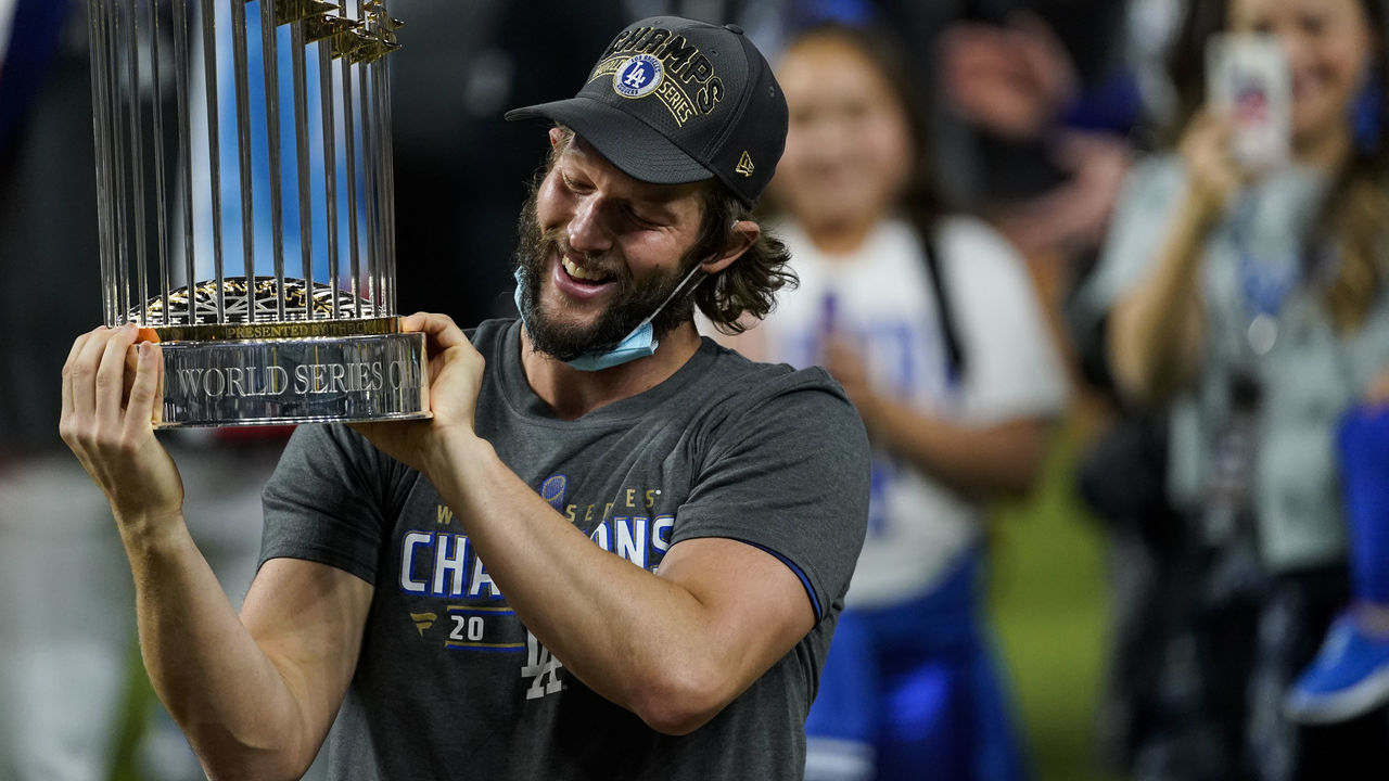 ARLINGTON, TX - OCTOBER 27: Clayton Kershaw #22 of the Los Angeles Dodgers holds the commissioners trophy after defeating the Tampa Bay Rays 3-1 in Game Six to win the 2020 MLB World Series at Globe Life Field on Tuesday, October 27, 2020 in Arlington, Texas.