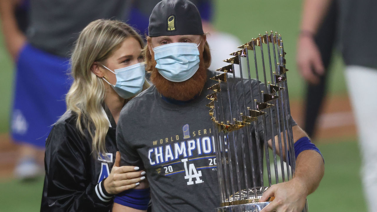 ARLINGTON, TEXAS - OCTOBER 27: Justin Turner #10 of the Los Angeles Dodgers and his wife Kourtney Pogue, hold the Commissioners Trophy after the teams 3-1 victory against the Tampa Bay Rays in Game Six to win the 2020 MLB World Series at Globe Life Field on October 27, 2020 in Arlington, Texas.