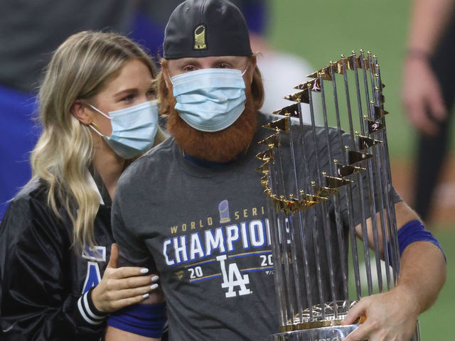 ARLINGTON, TEXAS - OCTOBER 27: Justin Turner #10 of the Los Angeles Dodgers and his wife Kourtney Pogue, hold the Commissioners Trophy after the teams 3-1 victory against the Tampa Bay Rays in Game Six to win the 2020 MLB World Series at Globe Life Field on October 27, 2020 in Arlington, Texas.