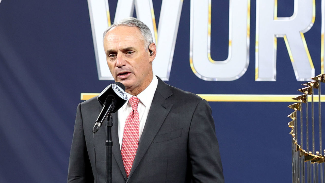 ARLINGTON, TX - OCTOBER 27: Major League Baseball Commissioner Robert D. Manfred Jr. presents the Commissioners Trophy to Los Angeles Dodgers Owner Mark Walter after the Dodgers defeated the Tampa Bay Rays in Game 6 to clinch the 2020 World Series at Globe Life Field on Tuesday, October 27, 2020 in Arlington, Texas.
