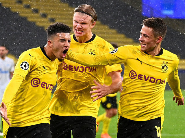 DORTMUND, GERMANY - OCTOBER 28: Jadon Sancho of Borussia Dortmund celebrates with teammates Thorgan Hazard and Erling Haaland after scoring his team's first goal from the penalty spot during the UEFA Champions League Group F stage match between Borussia Dortmund and Zenit St. Petersburg at Signal Iduna Park on October 28, 2020 in Dortmund, Germany. Sporting stadiums around Dortmund remain under strict restrictions due to the Coronavirus Pandemic as Government social distancing laws prohibit fans inside venues resulting in games being played behind closed doors.