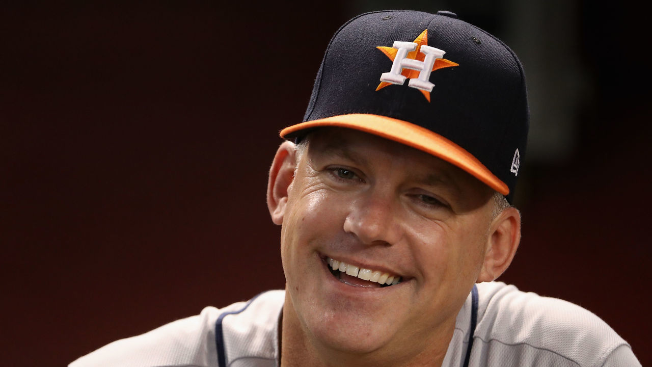 PHOENIX, AZ - AUGUST 14: Manager A.J. Hinch #14 of the Houston Astros laughs in the dugout before the MLB game against the Arizona Diamondbacks at Chase Field on August 14, 2017 in Phoenix, Arizona.