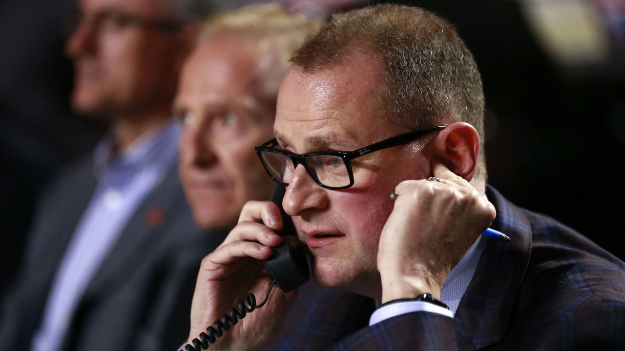 VANCOUVER, BRITISH COLUMBIA - JUNE 21: General manager Brad Treliving of the Calgary Flames talks on the phone from the team draft table during the first round of the 2019 NHL Draft at Rogers Arena on June 21, 2019 in Vancouver, Canada.