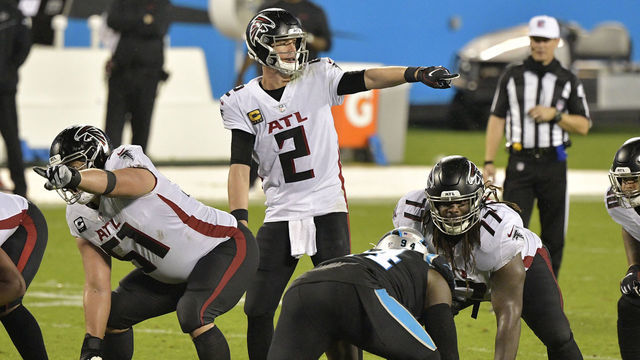CHARLOTTE, NORTH CAROLINA - OCTOBER 29: Matt Ryan #2 and Alex Mack #51 of the Atlanta Falcons point out the Carolina Panthers defense during the third quarter at Bank of America Stadium on October 29, 2020 in Charlotte, North Carolina.