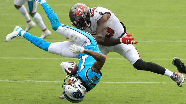 TAMPA, FLORIDA - SEPTEMBER 20: Robby Anderson #11 of the Carolina Panthers is upended as he is tackled by Jason Pierre-Paul #90 and Sean Murphy-Bunting #23 (not pictured) of the Tampa Bay Buccaneers during the third quarter at Raymond James Stadium on September 20, 2020 in Tampa, Florida.