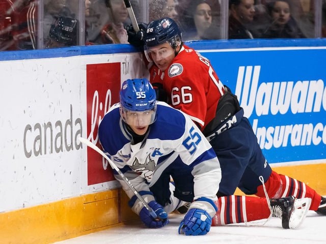 OSHAWA, ON - FEBRUARY 7: Nico Gross #66 of the Oshawa Generals checks Quinton Byfield #55 of the Sudbury Wolves during an OHL game at the Tribute Communities Centre on February 7, 2020 in Oshawa, Ontario, Canada.