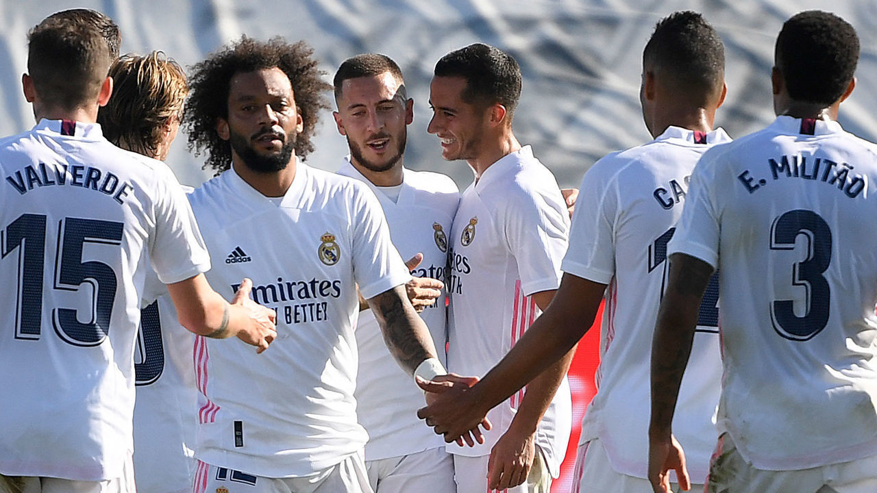 Real Madrid's Belgian forward Eden Hazard (C-L) celebrates with teammates after scoring a goal during the Spanish League football match between Real Madrid and SD Huesca at the Alfredo Di Stefano stadium in Valdebebas, northeastern Madrid, on October 31, 2020.