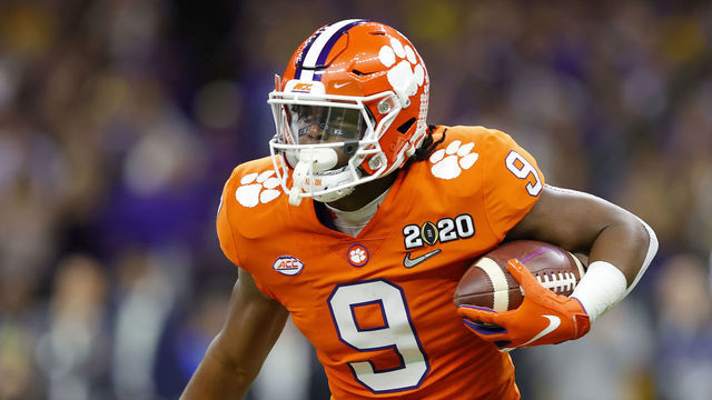 NEW ORLEANS, LOUISIANA - JANUARY 13: Travis Etienne #9 of the Clemson Tigers runs the ball against Derion Kendrick #1 of the Clemson Tigers during the first quarter in the College Football Playoff National Championship game at Mercedes Benz Superdome on January 13, 2020 in New Orleans, Louisiana.