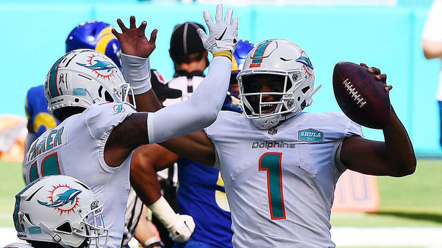 MIAMI GARDENS, FLORIDA - NOVEMBER 01: Tua Tagovailoa #1 of the Miami Dolphins celebrates his first NFL touchdown on a three-yard pass to DeVante Parker #11 against the Los Angeles Rams during their game at Hard Rock Stadium on November 01, 2020 in Miami Gardens, Florida.