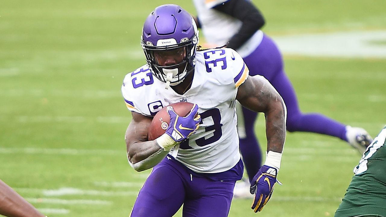 GREEN BAY, WISCONSIN - NOVEMBER 01: Dalvin Cook #33 of the Minnesota Vikings runs the ball as Aaron Jones #33 of the Green Bay Packers defends during the second quarter of the game at Lambeau Field on November 01, 2020 in Green Bay, Wisconsin.