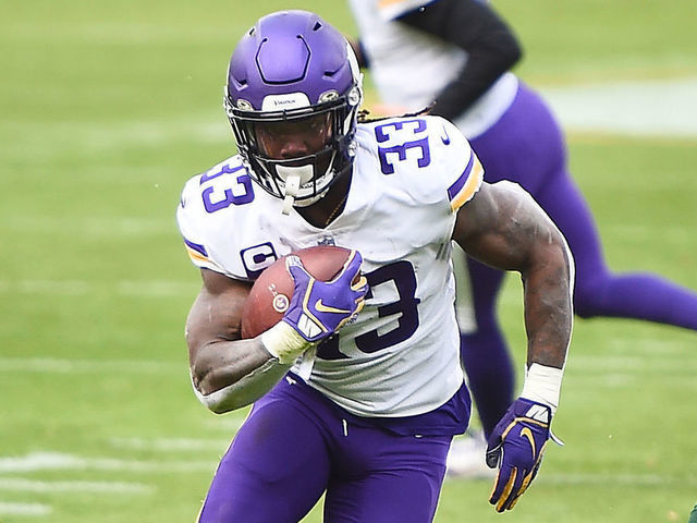 GREEN BAY, WISCONSIN - NOVEMBER 01: Dalvin Cook #33 of the Minnesota Vikings runs the ball as Aaron Jones #33 of the Green Bay Packers defends during the second quarter of the game at Lambeau Field on November 01, 2020 in Green Bay, Wisconsin.