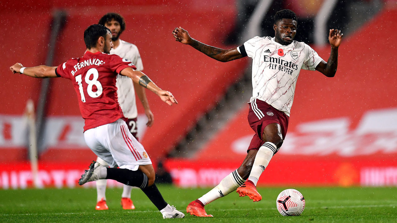 Manchester United's Bruno Fernandes and Arsenals Thomas Partey battle for the ball during the Premier League match at Old Trafford, Manchester.