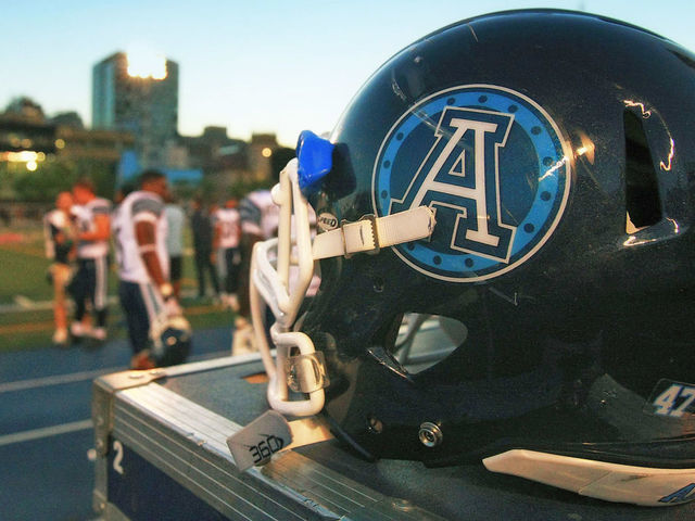 TORONTO, ON - JUNE 19: A helmet of the Toronto Argonauts on the side of the field as the Argonauts face the Hamilton Tiger-Cats during their game at Varsity Stadium on June 19, 2014 in Toronto, Canada.