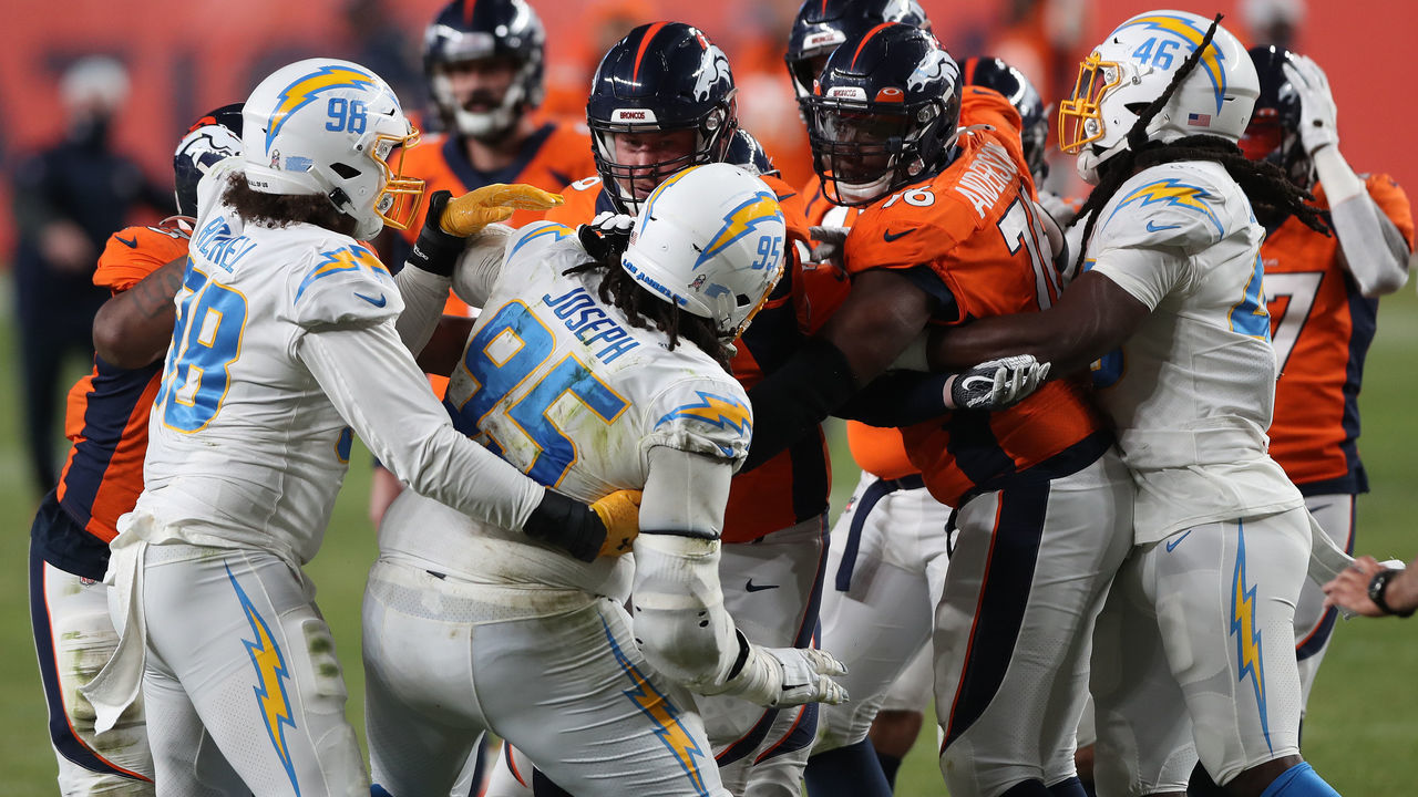 DENVER, COLORADO - NOVEMBER 01: Jake Rodgers #69 of the Denver Broncos and Linval Joseph #95 of the Los Angeles Chargers get aggressive after KJ Hamler #13 (not pictured) of the Denver Broncos scored a game-tying touchdown in the fourth qurater at Empower Field At Mile High on November 01, 2020 in Denver, Colorado. The Broncos won 31-30.
