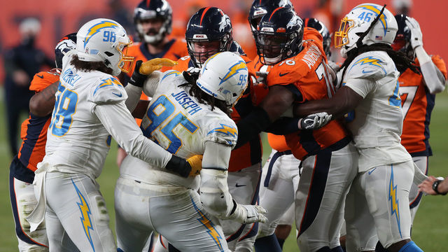 DENVER, COLORADO - NOVEMBER 01: Jake Rodgers #69 of the Denver Broncos and Linval Joseph #95 of the Los Angeles Chargers get aggressive after KJ Hamler #13 (not pictured) of the Denver Broncos scored a game-tying touchdown in the fourth qurater at Empower Field At Mile High on November 01, 2020 in Denver, Colorado. The Broncos won 31-30.