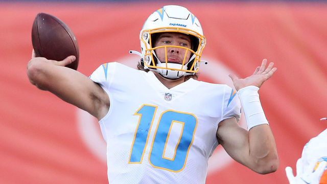 DENVER, COLORADO - NOVEMBER 01: Quarterback Justin Herbert #10 of the Los Angeles Chargers looks to pass against Dre'Mont Jones #93 of the Denver Broncos in the second quarter of the game at Empower Field At Mile High on November 01, 2020 in Denver, Colorado.