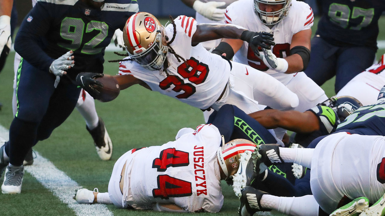 SEATTLE, WASHINGTON - NOVEMBER 01: JaMycal Hasty #38 of the San Francisco 49ers scores a touchdown against Bryan Mone #92 of the Seattle Seahawks in the second quarter of the game at CenturyLink Field on November 01, 2020 in Seattle, Washington.