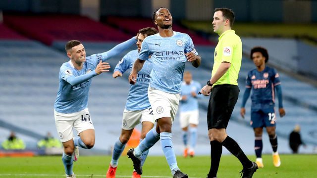 Manchester City's Raheem Sterling (centre) celebrates scoring his side's first goal of the game during the Premier League match at the Etihad Stadium, Manchester.