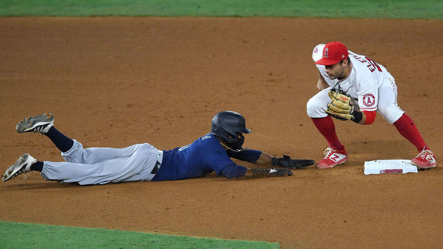 ANAHEIM, CA - JULY 30: David Fletcher #22 of the Los Angeles Angels makes the tag as Mallex Smith #0 of the Seattle Mariners is picked off at second on a throw by Felix Peña #64 of the Los Angeles Angels in the seventh inning of the game at Angel Stadium of Anaheim on July 30, 2020 in Anaheim, California.