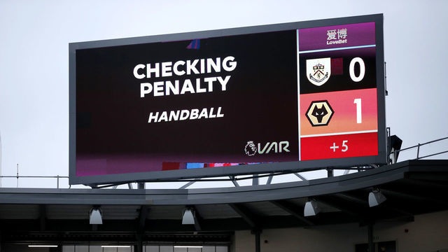 BURNLEY, ENGLAND - JULY 15: The big screen shows the VAR check for a possible penalty for handball during the Premier League match between Burnley FC and Wolverhampton Wanderers at Turf Moor on July 15, 2020 in Burnley, England. Football Stadiums around Europe remain empty due to the Coronavirus Pandemic as Government social distancing laws prohibit fans inside venues resulting in all fixtures being played behind closed doors.
