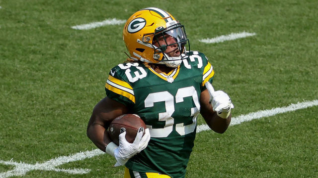 GREEN BAY, WISCONSIN - SEPTEMBER 20: Aaron Jones #33 of the Green Bay Packers runs with the ball in the third quarter against the Detroit Lions at Lambeau Field on September 20, 2020 in Green Bay, Wisconsin.