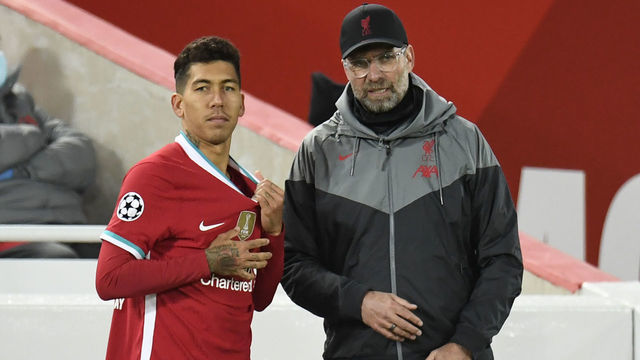 Liverpool's German manager Jurgen Klopp (R) speaks with Liverpool's Brazilian midfielder Roberto Firmino (L) before he goes on as substitute during the UEFA Champions league Group D football match between Liverpool and Midtjylland at Anfield in Liverpool, north west England on October 27, 2020.