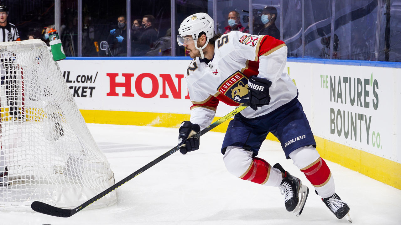 TORONTO, ONTARIO - AUGUST 04: MacKenzie Weegar #52 of the Florida Panthers plays the puck against the New York Islanders during the first period in Game Two of the Eastern Conference Qualification Round at Scotiabank Arena on August 04, 2020 in Toronto, Ontario.