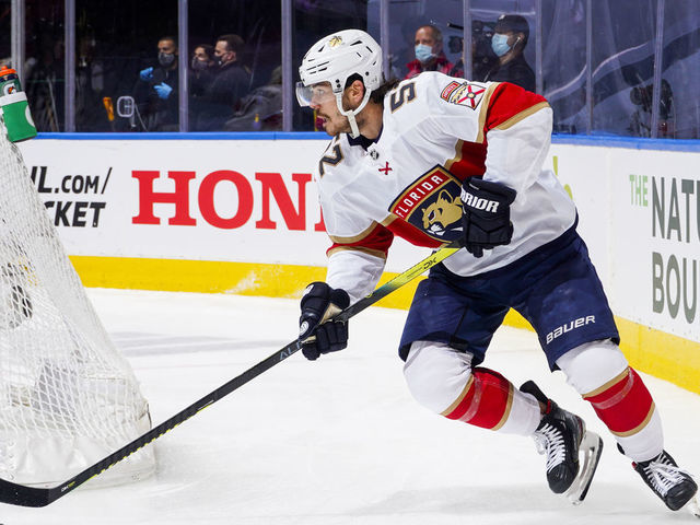 TORONTO, ONTARIO - AUGUST 04: MacKenzie Weegar #52 of the Florida Panthers plays the puck against the New York Islanders during the first period in Game Two of the Eastern Conference Qualification Round at Scotiabank Arena on August 04, 2020 in Toronto, Ontario.