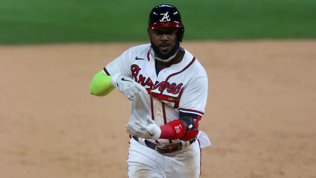 ARLINGTON, TEXAS - OCTOBER 15: Marcell Ozuna #20 of the Atlanta Braves celebrates after hitting a solo home run against the Los Angeles Dodgers during the seventh inning in Game Four of the National League Championship Series at Globe Life Field on October 15, 2020 in Arlington, Texas.