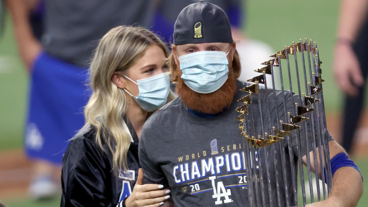 ARLINGTON, TEXAS - OCTOBER 27: Justin Turner #10 of the Los Angeles Dodgers and his wife Kourtney Pogue, hold the Commissioners Trophy after the teams 3-1 victory against the Tampa Bay Rays in Game Six to win the 2020 MLB World Series at Globe Life Field on October 27, 2020 in Arlington, Texas.