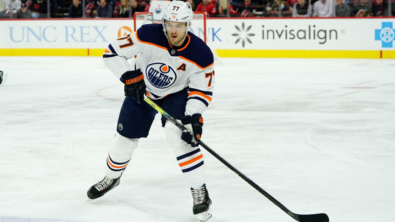 RALEIGH, NC - FEBRUARY 16: Oscar Klefbom #77 of the Edmonton Oilers prepares pass the puck during an NHL game against the Carolina Hurricanes on February 16, 2020 at PNC Arena in Raleigh, North Carolina.
