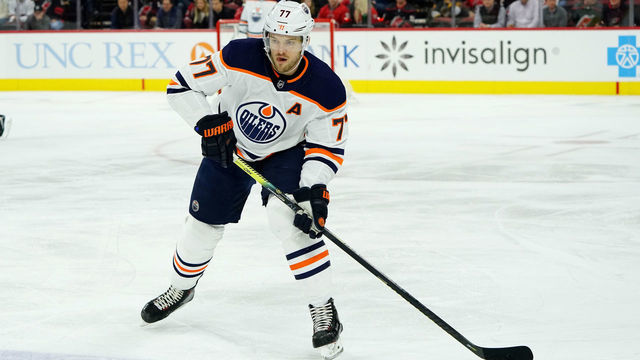 RALEIGH, NC - FEBRUARY 16: Oscar Klefbom #77 of the Edmonton Oilers prepares pass the puck during an NHL game against the Carolina Hurricanes on February 16, 2020 at PNC Arena in Raleigh, North Carolina.