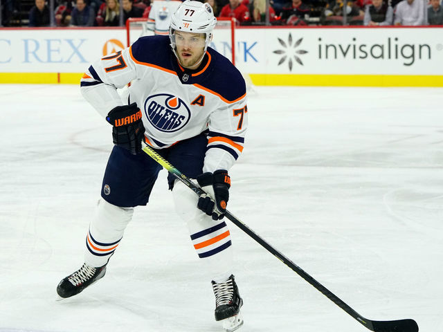 RALEIGH, NC - FEBRUARY 16: Oscar Klefbom #77 of the Edmonton Oilers prepares pass the puck during an NHL game against the Carolina Hurricanes on February 16, 2020 at PNC Arena in Raleigh, North Carolina.