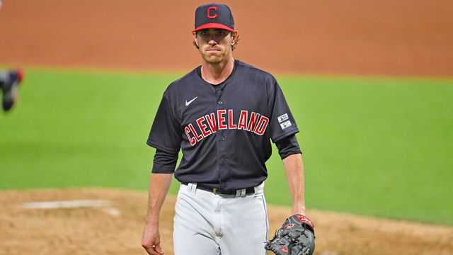 CLEVELAND, OHIO - JULY 24: Starting pitcher Shane Bieber #57 of the Cleveland Indians walks back to the dugout after the end of the top of the sixth inning of the Opening Day game against the Kansas City Royals at Progressive Field on July 24, 2020 in Cleveland, Ohio. The Indians defeated the Royals 2-0. The 2020 season had been postponed since March due to the COVID-19 pandemic.