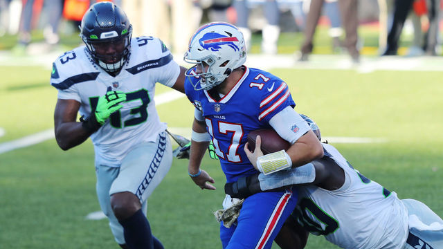 ORCHARD PARK, NEW YORK - NOVEMBER 08: Jarran Reed #90 of the Seattle Seahawks dives to tackle Josh Allen #17 of the Buffalo Bills during the second half at Bills Stadium on November 08, 2020 in Orchard Park, New York.