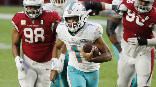 GLENDALE, ARIZONA - NOVEMBER 08: Tua Tagovailoa #1 of the Miami Dolphins carries the ball as Corey Peters #98 of the Arizona Cardinals gives chase during the second half at State Farm Stadium on November 08, 2020 in Glendale, Arizona.