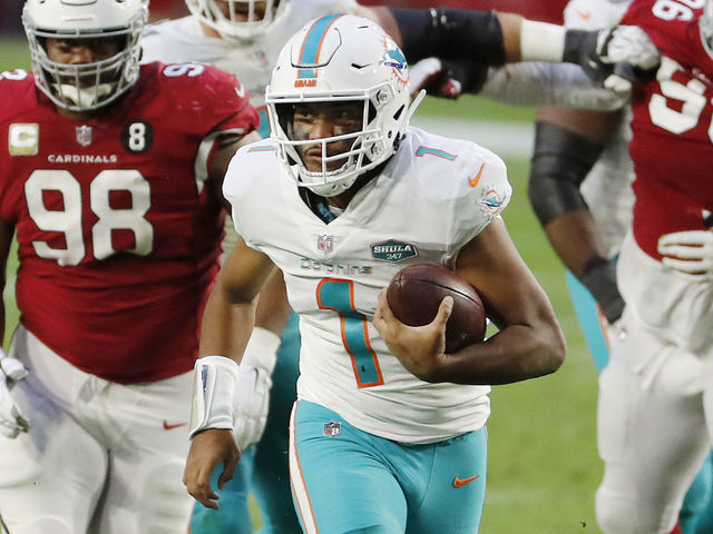 GLENDALE, ARIZONA - NOVEMBER 08: Tua Tagovailoa #1 of the Miami Dolphins carries the ball as Corey Peters #98 of the Arizona Cardinals gives chase during the second half at State Farm Stadium on November 08, 2020 in Glendale, Arizona.
