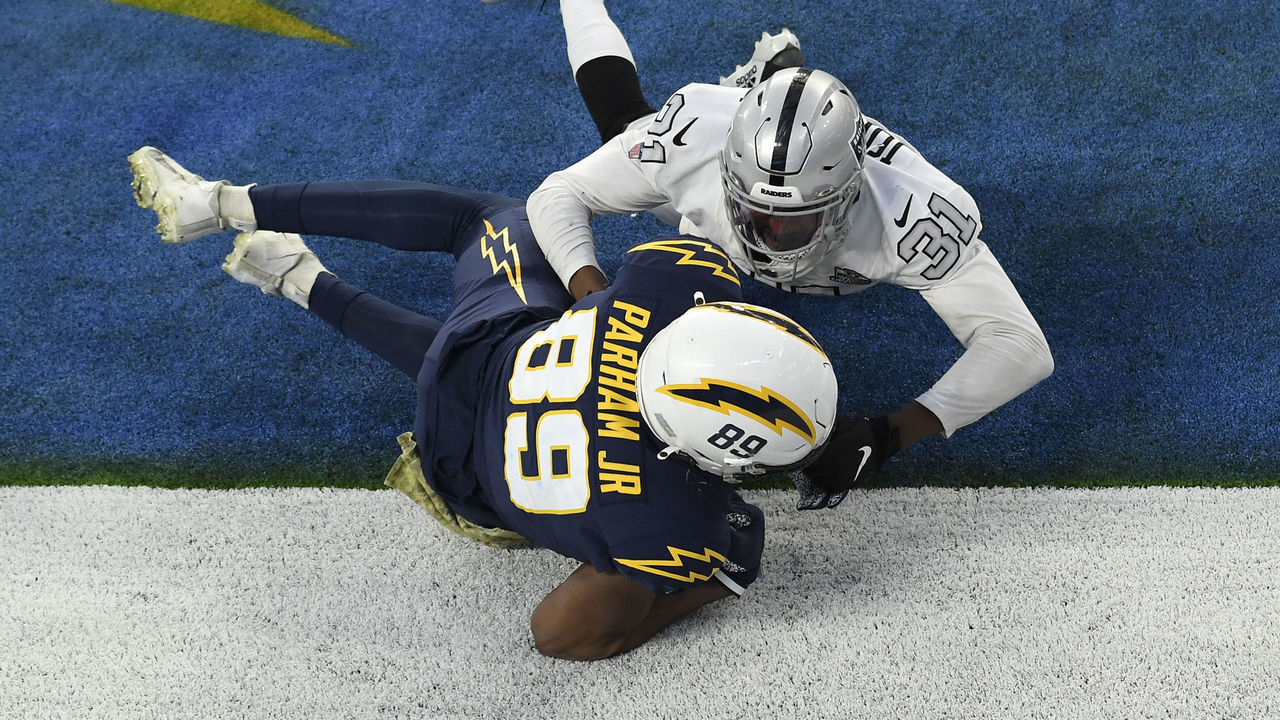 INGLEWOOD, CALIFORNIA - NOVEMBER 08: Donald Parham #89 of the Los Angeles Chargers tries to come down with a fourth quarter touchdown catch next to Isaiah Johnson #31 of the Las Vegas Raiders at SoFi Stadium on November 08, 2020 in Inglewood, California. The play was originally called a touchdown but was overturned on replay to give the Raiders a 31-26 win,